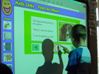 Child using an interactive whiteboard