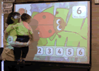 Child using an interactive whiteboard